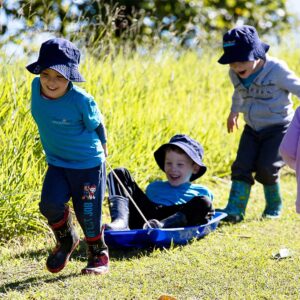 Early learner children on sled at Suncoast Little Leaners, Woombye